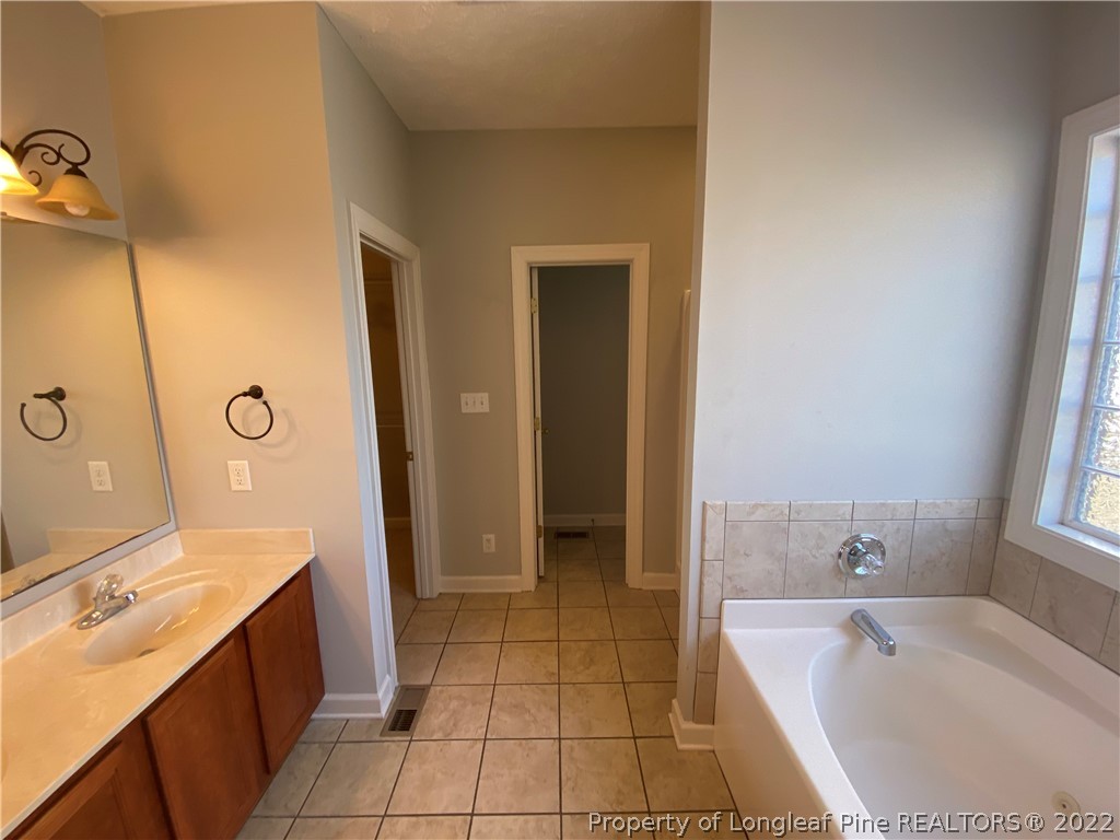 3532 Talus Road Fayetteville, NC 28306 - Photo 21 of 34 a spacious bathroom with a tub sink and mirror