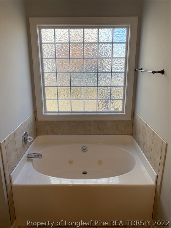 3532 Talus Road Fayetteville, NC 28306 - Photo 23 of 34 a white bath tub sitting in a bathroom next to a window