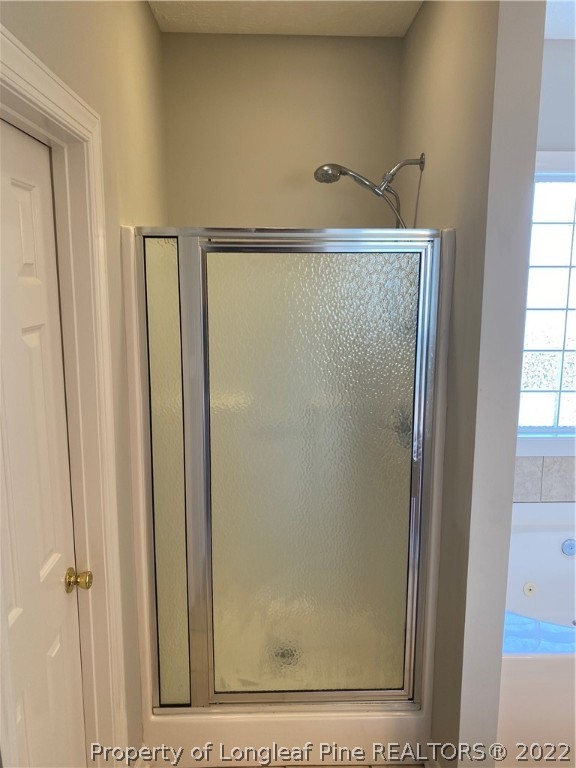 3532 Talus Road Fayetteville, NC 28306 - Photo 24 of 34 a bathroom with a glass shower door