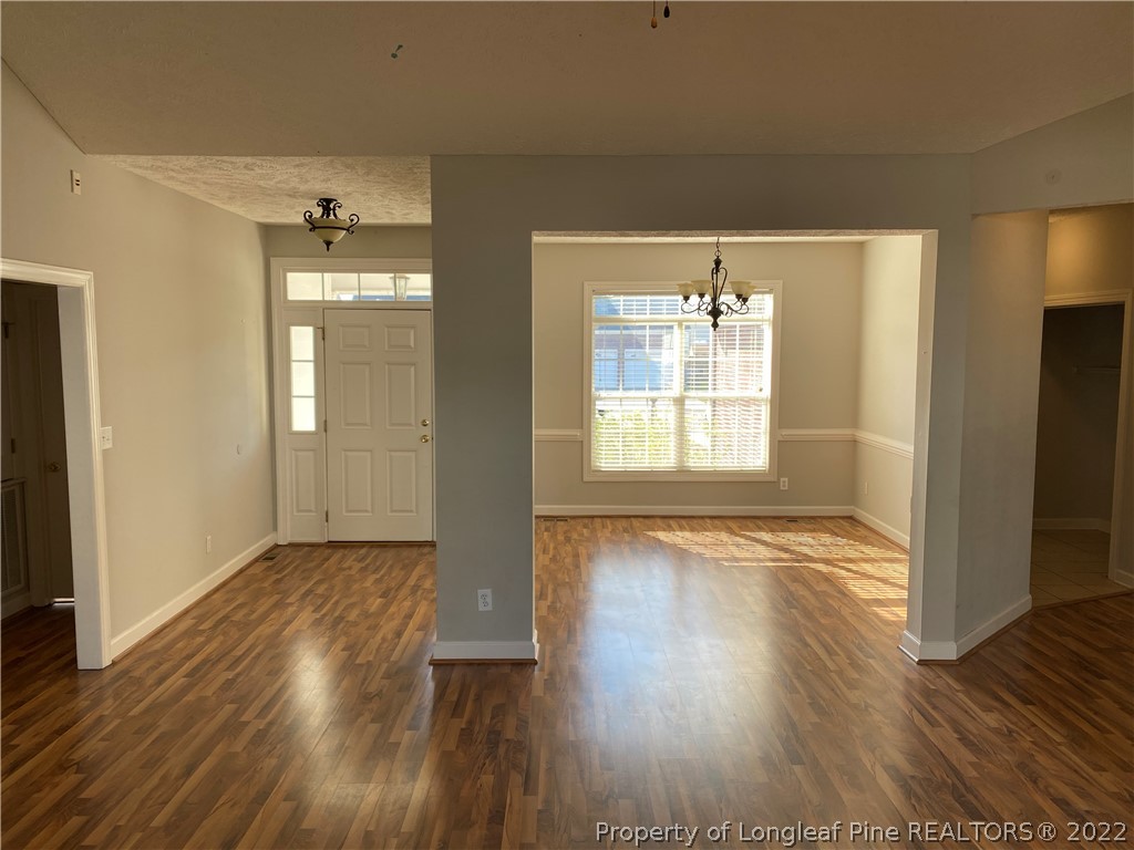 3532 Talus Road Fayetteville, NC 28306 - Photo 6 of 34 an empty room with wooden floor and windows