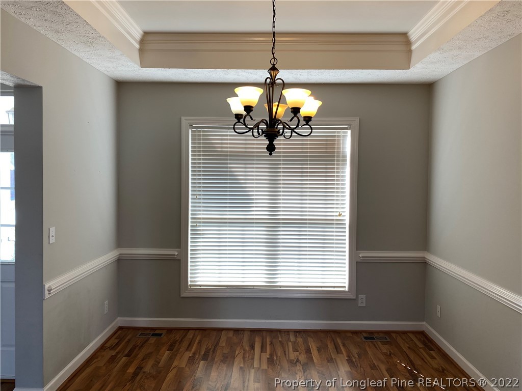 3532 Talus Road Fayetteville, NC 28306 - Photo 7 of 34 a view of a room with wooden floor and chandelier