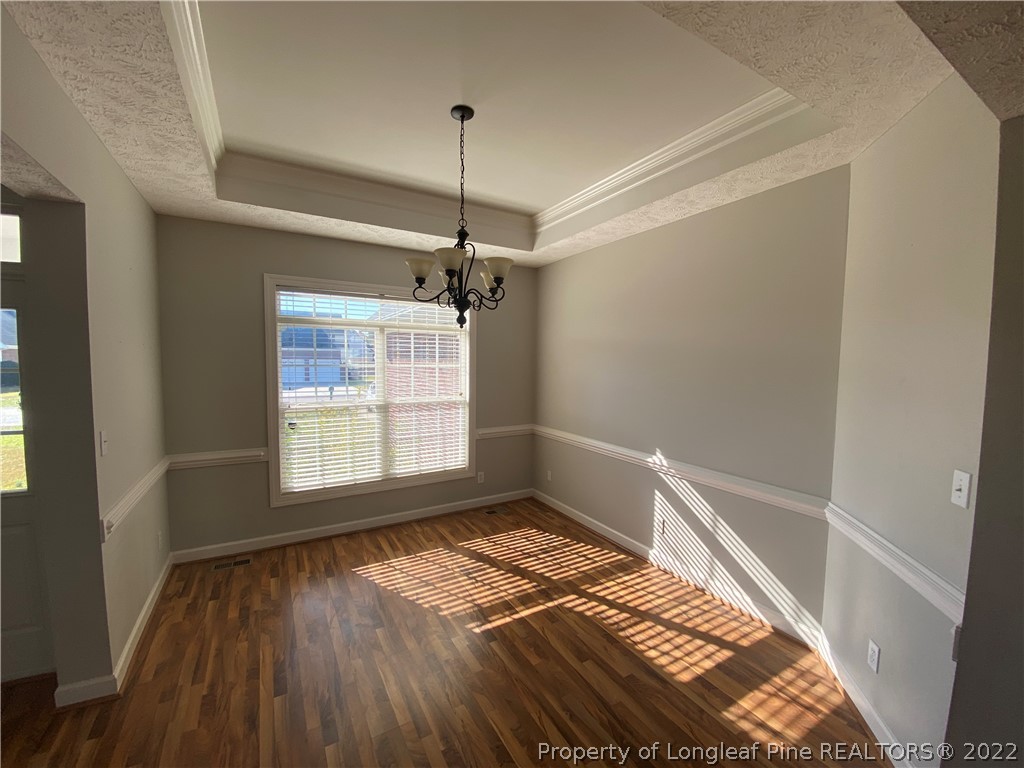3532 Talus Road Fayetteville, NC 28306 - Photo 8 of 34 a view of a room with wooden floor a ceiling fan and window
