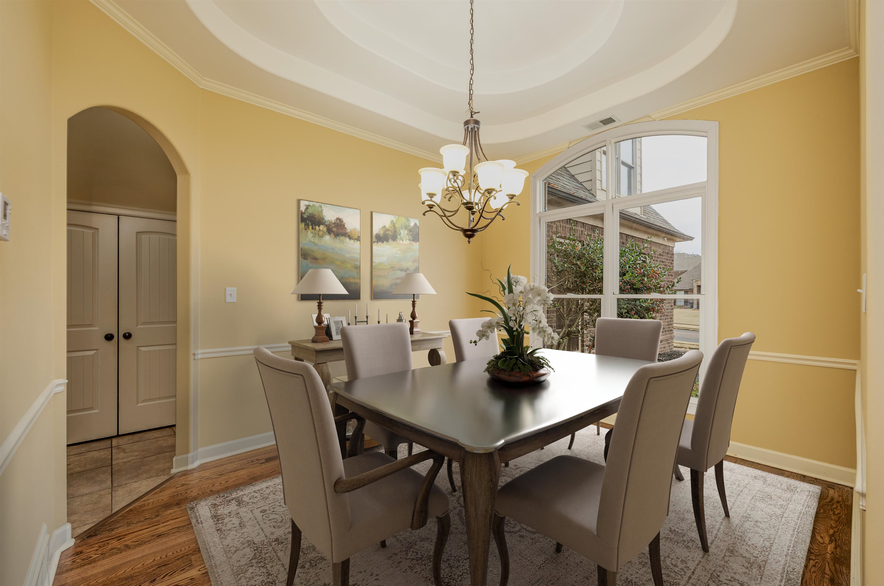 5380 Scarlet Ridge Drive Arlington, TN 38002 - Photo 5 of 30 Dining space with arched walkways, wood finished floors, a tray ceiling, and ornamental molding