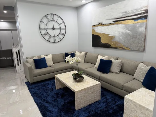 a living room with furniture and a rug