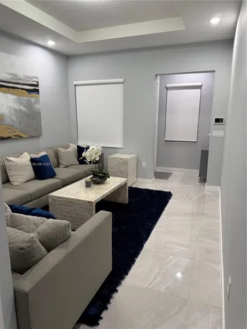 a living room with furniture and a mirror