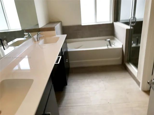 a bathroom with a bathtub and a sink