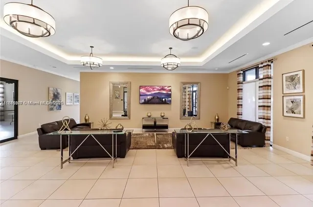 a living room with furniture a chandelier and a chandelier