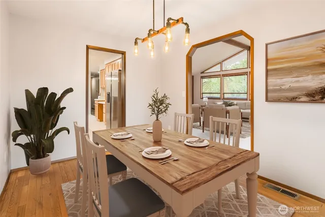 a view of a dining room with furniture and wooden floor