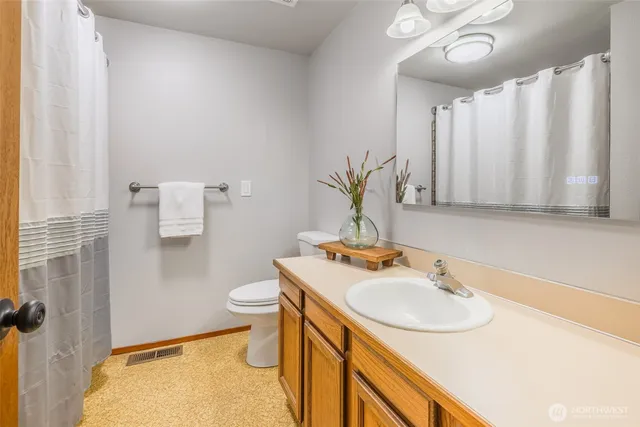 a bathroom with a sink toilet and a mirror