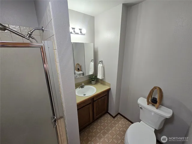 a bathroom with a toilet sink and mirror
