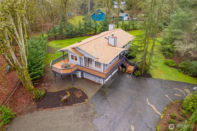 a aerial view of a house with a yard and lake view