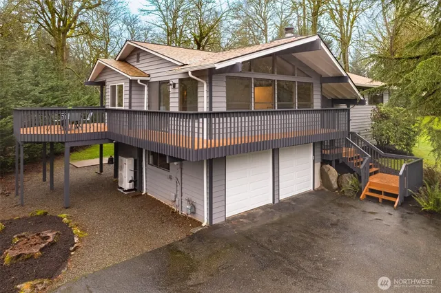 a view of a house with a patio and backyard