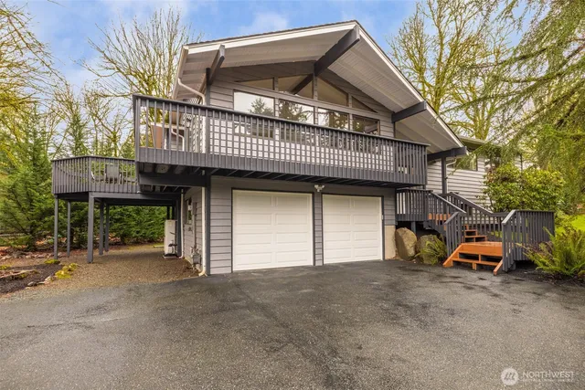 a view of a house with a car parked beside it
