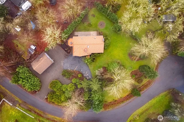 an aerial view of a house with a yard swimming pool and outdoor seating