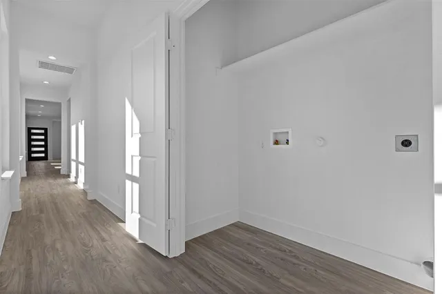 a view of a hallway with wooden floor