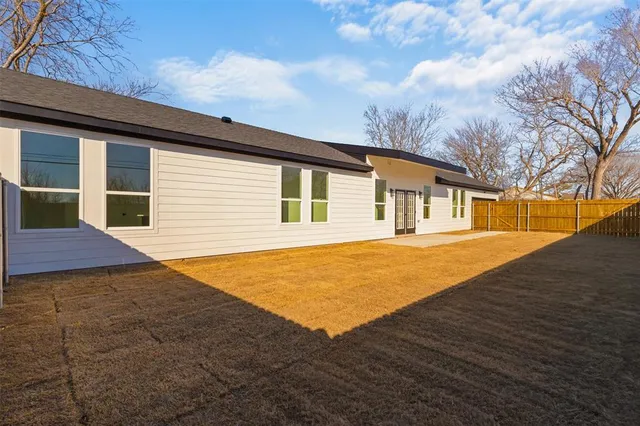 a backyard of a house with large trees
