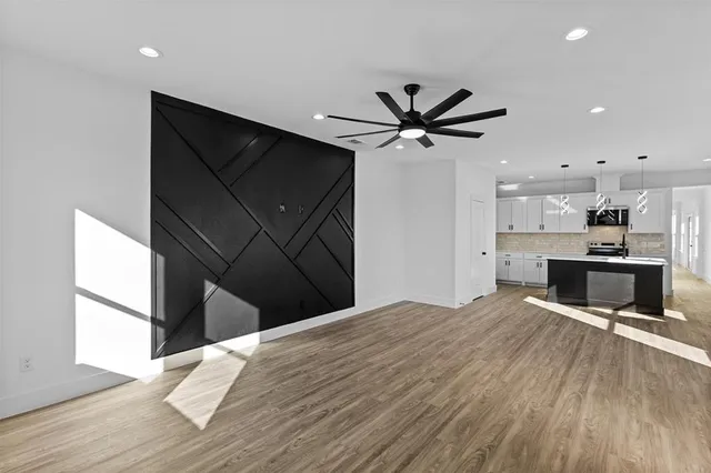 a view of a kitchen with a sink and a refrigerator