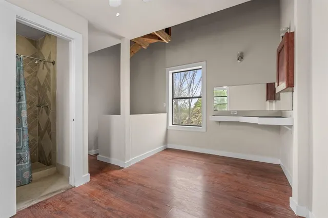 a view of a yard in front of a house with large trees