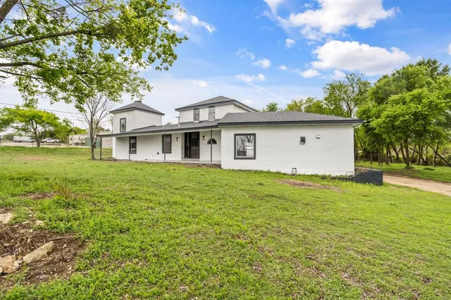 a front view of house with yard and trees