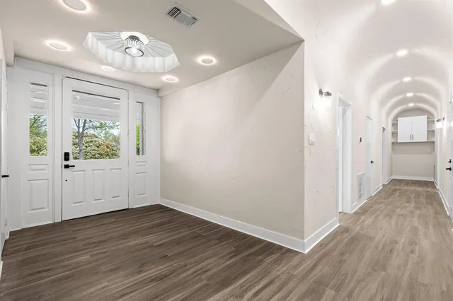 a view of a room with wooden floor and window