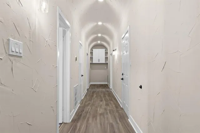 a view of a hallway view with wooden floor and staircase