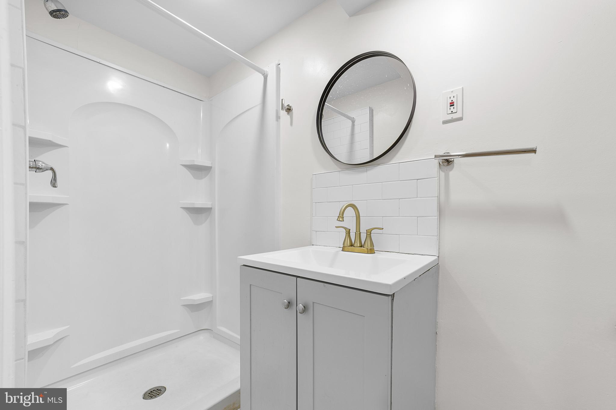 320 West Maple Avenue Merchantville, NJ 08109 - Photo 62 of 67 a bathroom with a sink a mirror a toilet and a shower