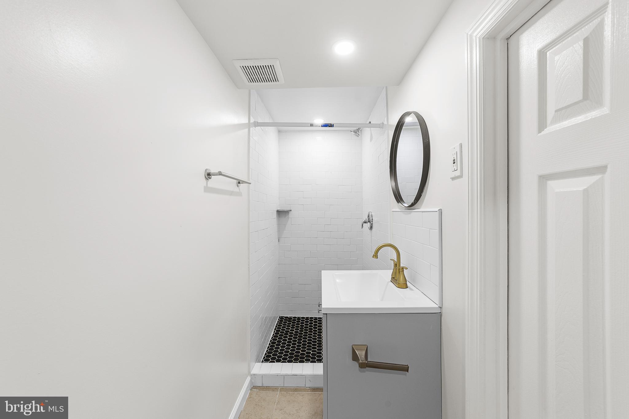 320 West Maple Avenue Merchantville, NJ 08109 - Photo 63 of 67 a bathroom with a sink and mirror with shower