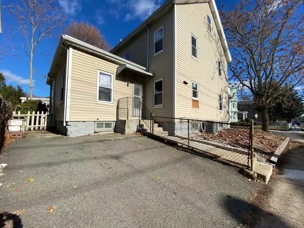 a view of a house with wooden fence