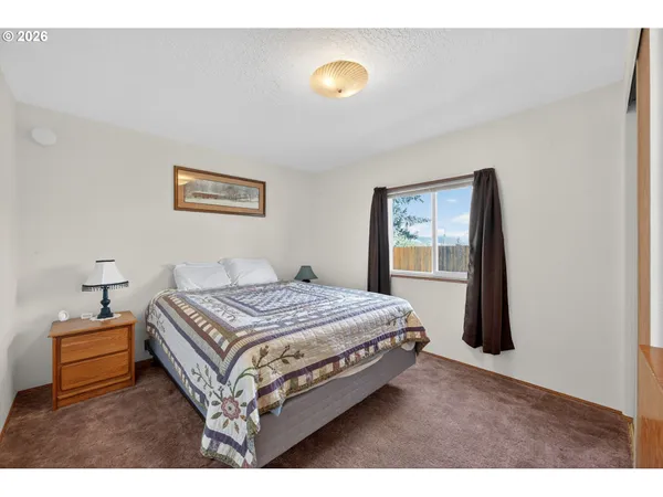 a bedroom with a bed and painting on the wall