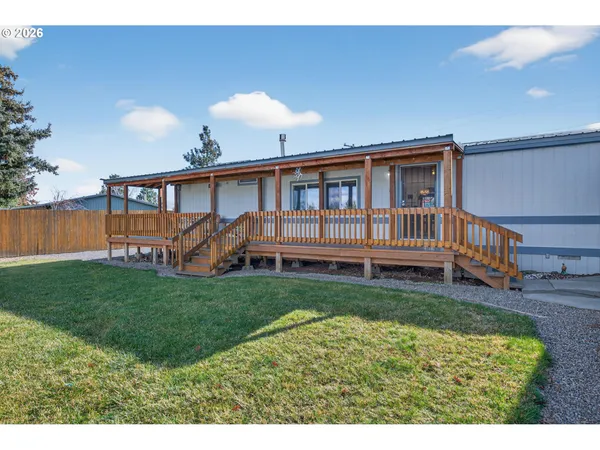 a view of a backyard with wooden fence