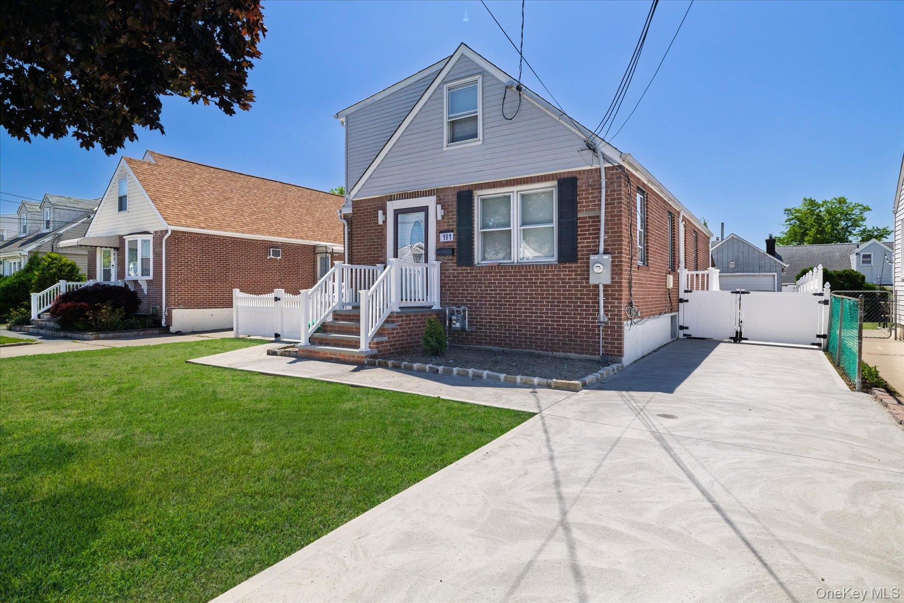 191 Raff Avenue Mineola, NY 11501 - Photo 3 of 25 a front view of a house with a yard