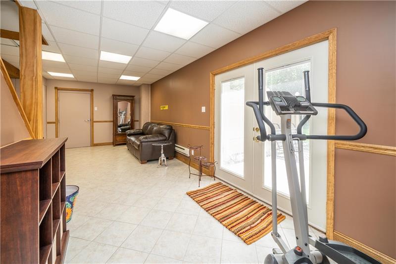 145 Elmbrook Road Beaver Falls, PA 15010 - Photo 18 of 25 Finished basement has ceramic flooring and french doors leading to stamped patio and gazebo with hot tub!