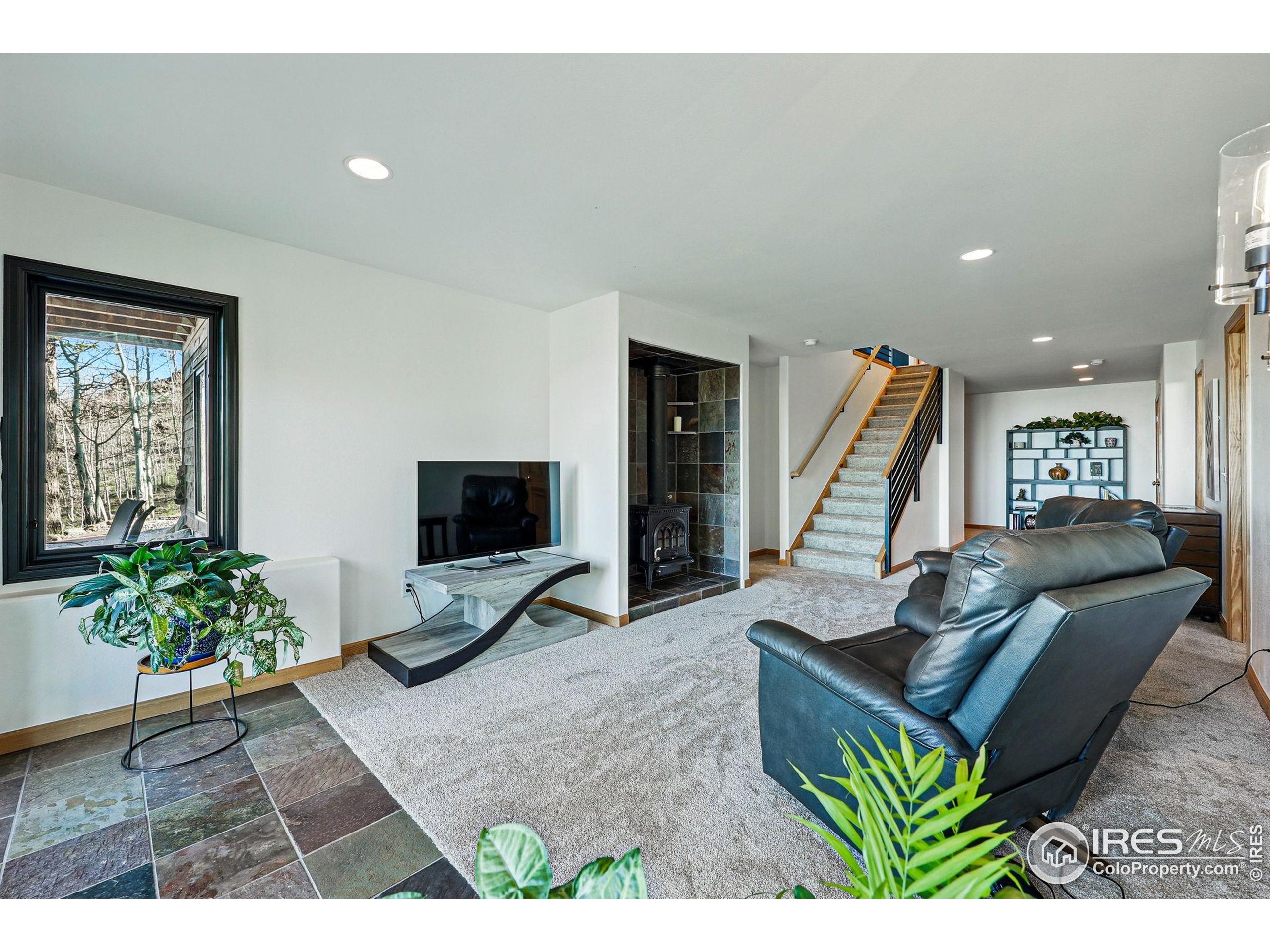 98 Rim Road Boulder, CO 80302 - Photo 23 of 43 a living room with furniture and a flat screen tv