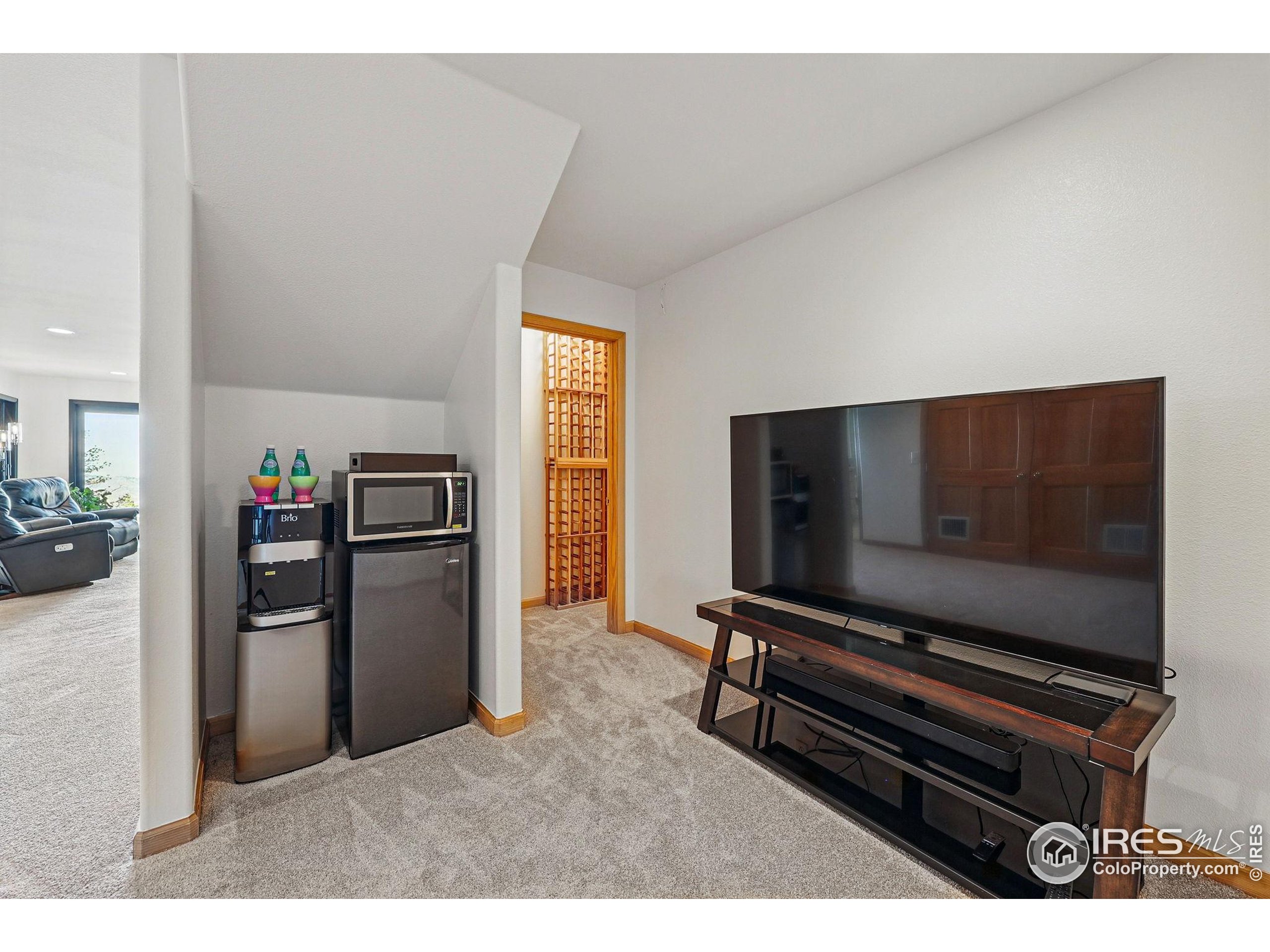 98 Rim Road Boulder, CO 80302 - Photo 25 of 43 a living room with furniture and a flat screen tv