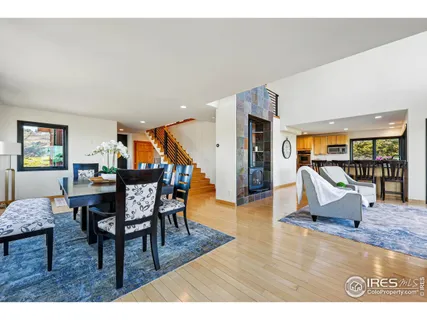 a dining room with furniture and wooden floor