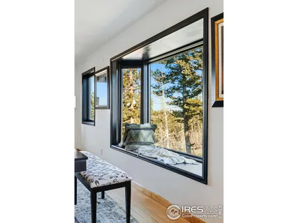 a view of a room that has a bed and a window with outer view