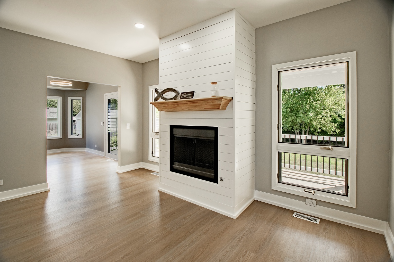33485 North Mill Road Grayslake, IL 60030 - Photo 5 of 28 an empty room with wooden floor a fireplace and windows