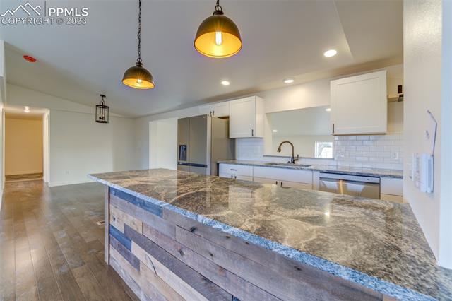 12610 North Condor Road Peyton, CO 80831 - Photo 9 of 34 Country living at it's best. Granite topped seating island