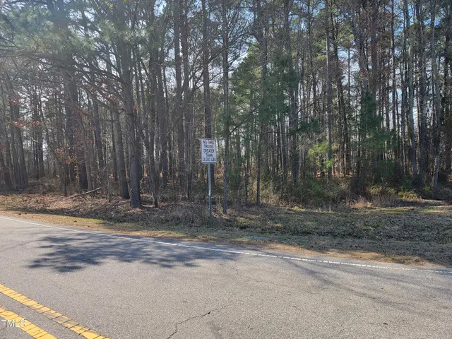 a view of a house with large trees