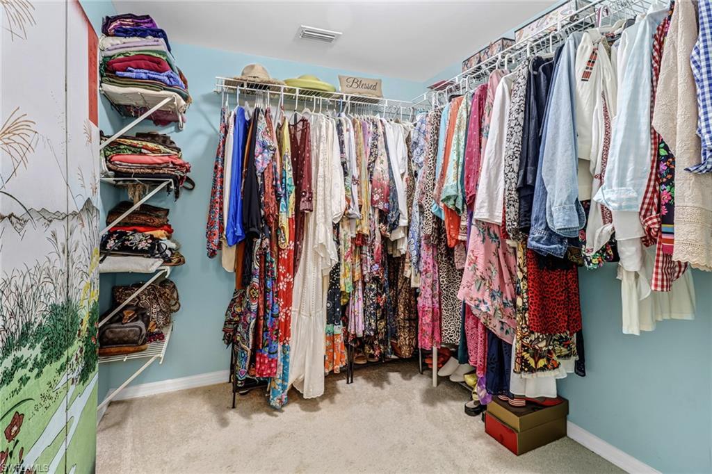 3041 Sandpiper Bay Circle, Unit H201 Naples, FL 34112 - Photo 18 of 25 Spacious closet with light colored carpet