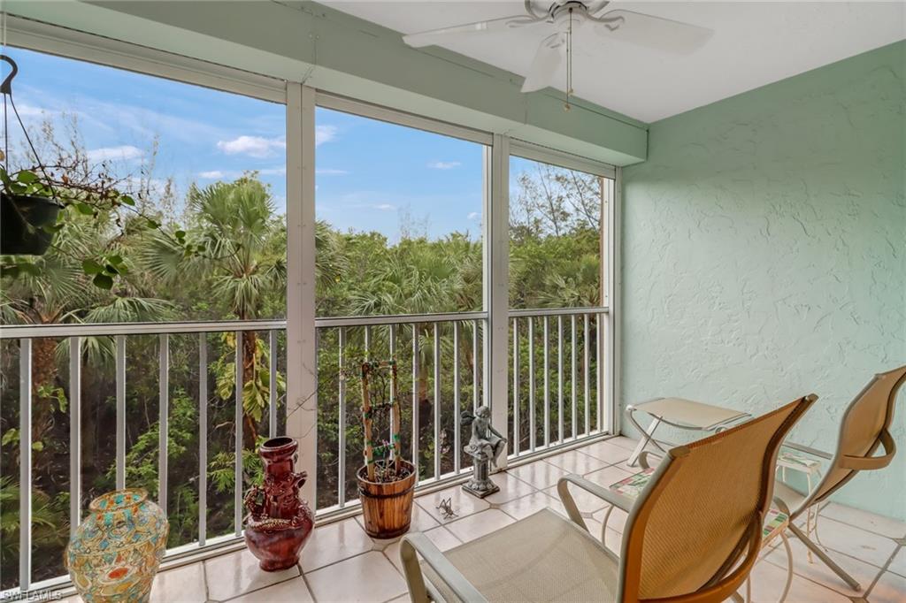 3041 Sandpiper Bay Circle, Unit H201 Naples, FL 34112 - Photo 22 of 25 Sunroom / solarium with a textured wall and tile patterned flooring