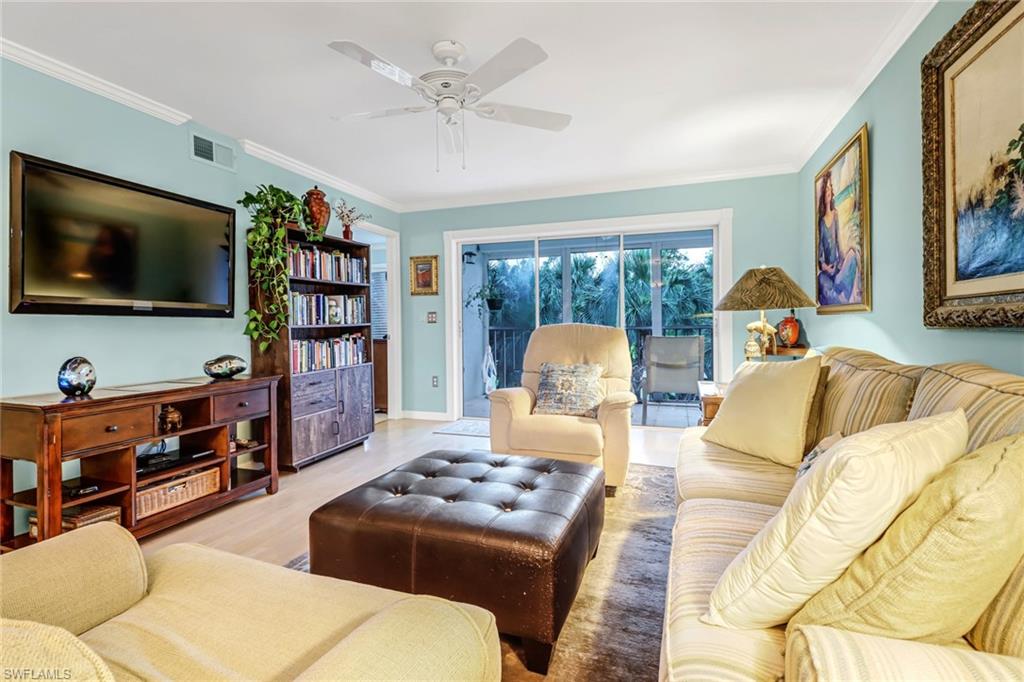 3041 Sandpiper Bay Circle, Unit H201 Naples, FL 34112 - Photo 8 of 25 Living room featuring ornamental molding, wood finished floors, and a ceiling fan