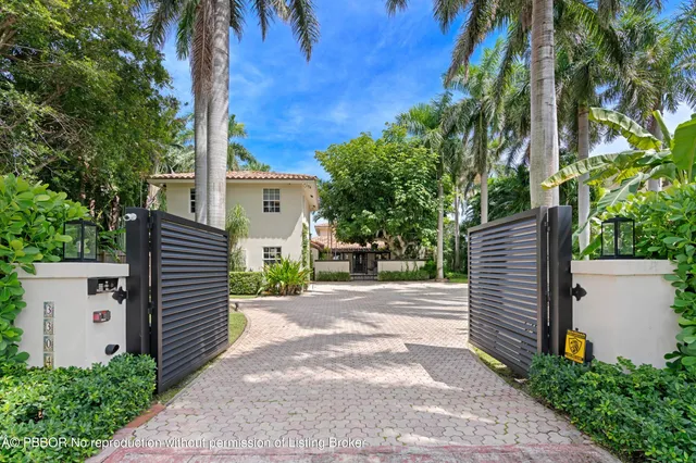 a dining room with wooden floor a chandelier a glass table and chairs