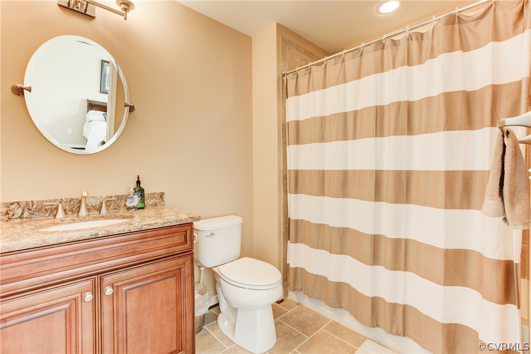 1106 Miners Trail Road Midlothian, VA 23114 - Photo 29 of 38 a bathroom with a sink a toilet a mirror and shower curtain