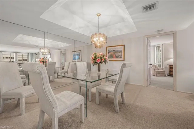 a view of a dining room with furniture and chandelier