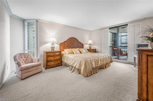 a spacious bedroom with a bed and a couch