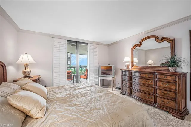 a bedroom with a bed and a dresser with mirror