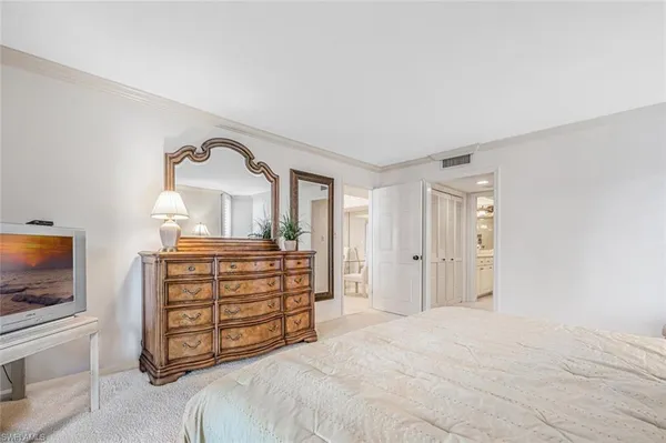 a bedroom with a bed and a television