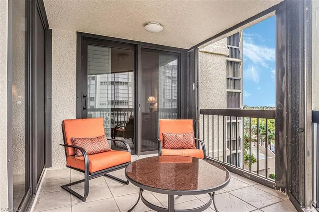 a balcony with view of wooden floor and fence