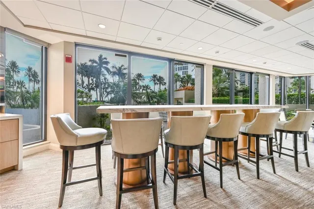 a room with gym equipment and large windows